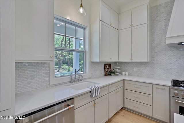 kitchen featuring decorative light fixtures, sink, plenty of natural light, and stainless steel appliances