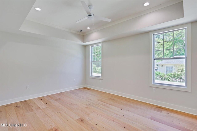 empty room with ceiling fan, ornamental molding, and light hardwood / wood-style flooring