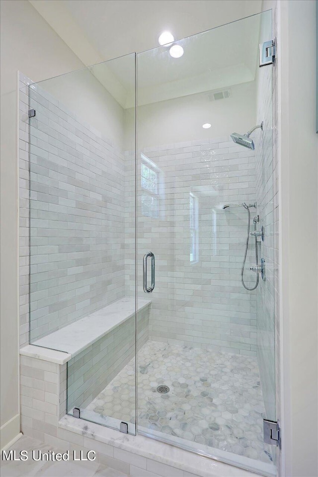 bathroom with a shower with door