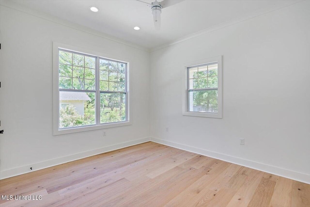 unfurnished room featuring ornamental molding, light hardwood / wood-style flooring, a healthy amount of sunlight, and ceiling fan