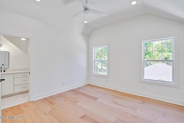 interior space with ceiling fan, lofted ceiling, and light hardwood / wood-style flooring