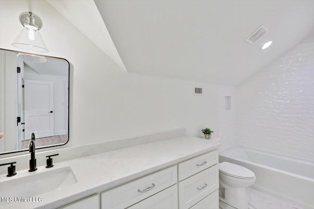 full bathroom with vanity, toilet, vaulted ceiling, and tiled shower / bath