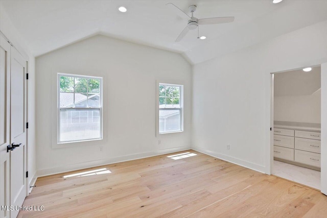 unfurnished bedroom with vaulted ceiling, light wood-type flooring, and ceiling fan