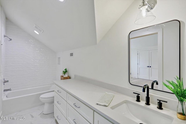 full bathroom with toilet, tiled shower / bath combo, vanity, and vaulted ceiling