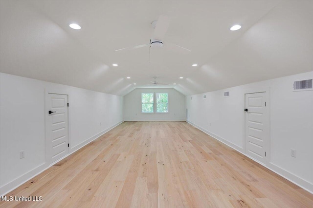 bonus room featuring vaulted ceiling and light wood-type flooring