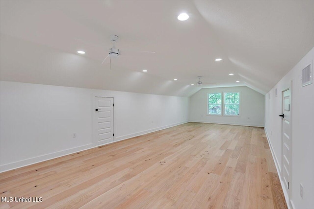 additional living space featuring lofted ceiling, light hardwood / wood-style flooring, and ceiling fan