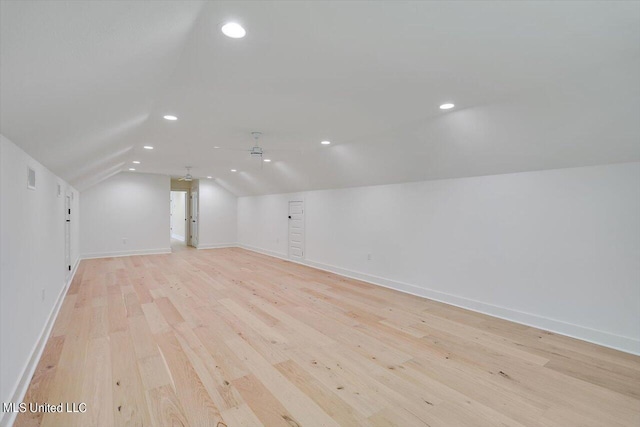 bonus room featuring vaulted ceiling and light hardwood / wood-style flooring