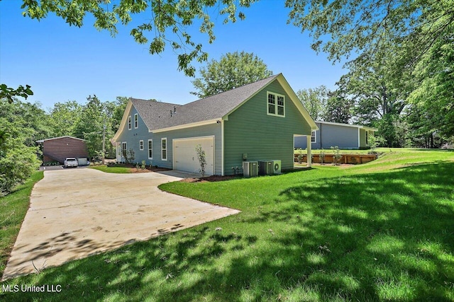 view of side of property featuring a garage and a lawn