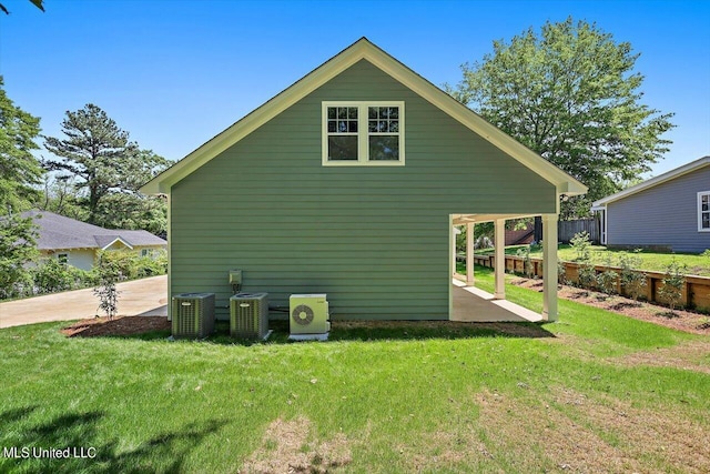 view of property exterior featuring a patio, central AC, and a yard