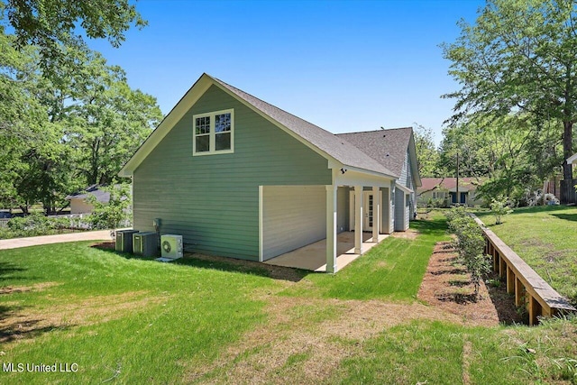 view of side of property featuring a patio area, cooling unit, and a lawn