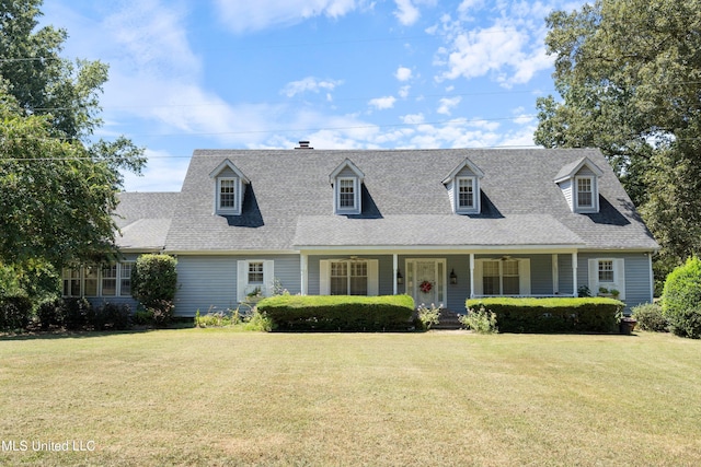 new england style home with covered porch and a front yard