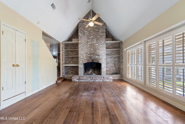 unfurnished living room with ceiling fan, wood-type flooring, lofted ceiling, and a fireplace