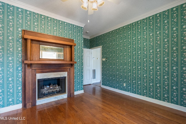 unfurnished living room with hardwood / wood-style floors, crown molding, a textured ceiling, and ceiling fan