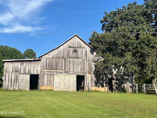 view of outbuilding with a yard