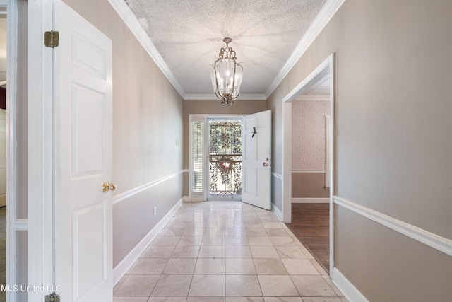 doorway to outside with light tile patterned flooring, crown molding, a textured ceiling, and a chandelier