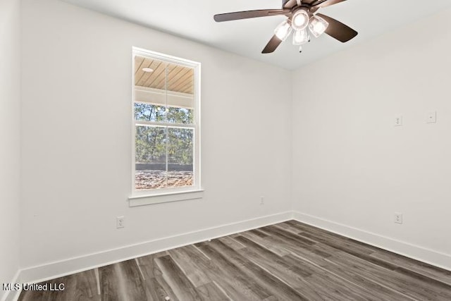 unfurnished room with ceiling fan, baseboards, and dark wood-type flooring