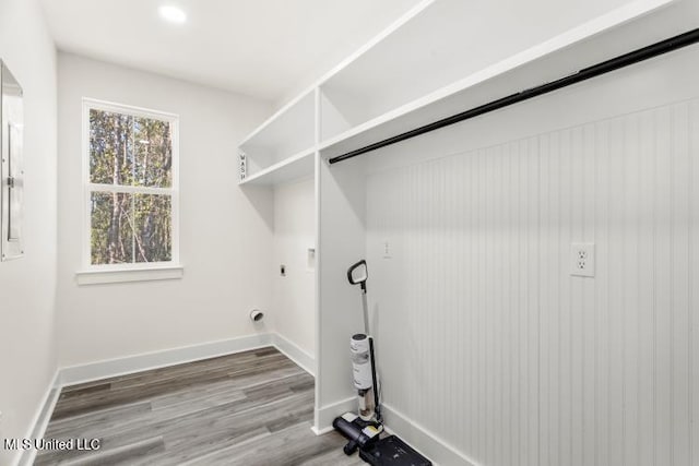 laundry area featuring baseboards, laundry area, and hookup for an electric dryer