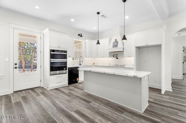 kitchen with double oven, white cabinetry, dark wood-type flooring, and dishwasher