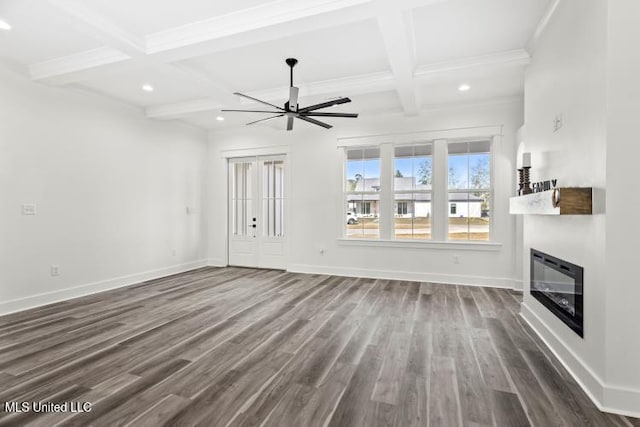 unfurnished living room featuring dark wood-style flooring, a glass covered fireplace, and baseboards