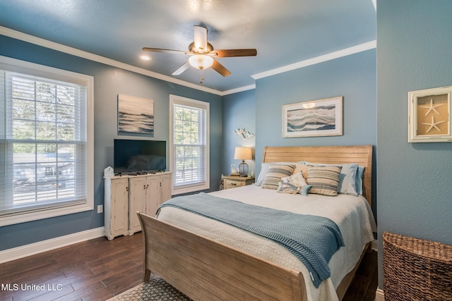 bedroom featuring dark hardwood / wood-style floors, ceiling fan, and crown molding