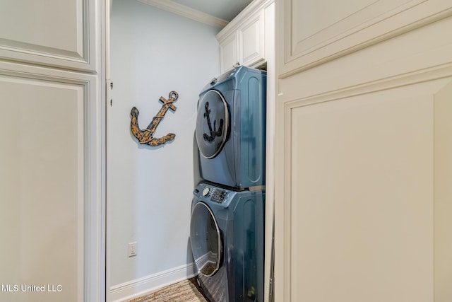 washroom featuring hardwood / wood-style floors, cabinets, stacked washer / drying machine, and ornamental molding