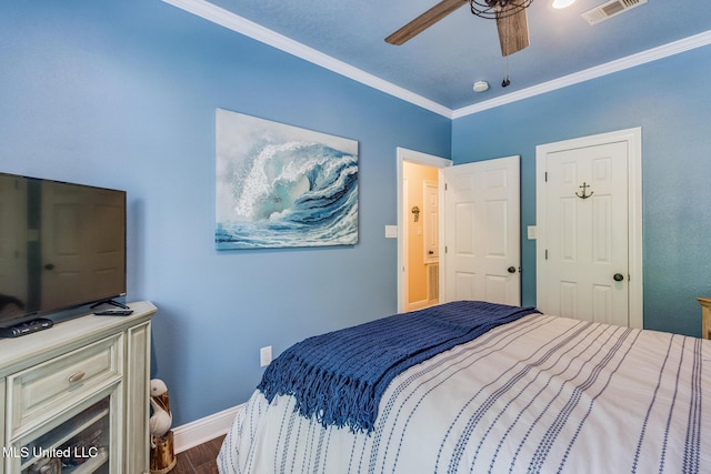 bedroom featuring ceiling fan, dark hardwood / wood-style flooring, and ornamental molding