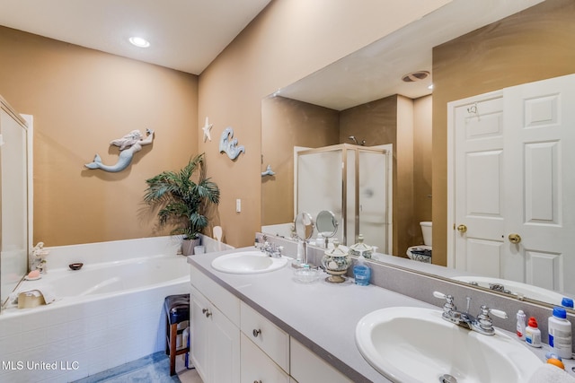 full bathroom featuring vanity, toilet, and independent shower and bath