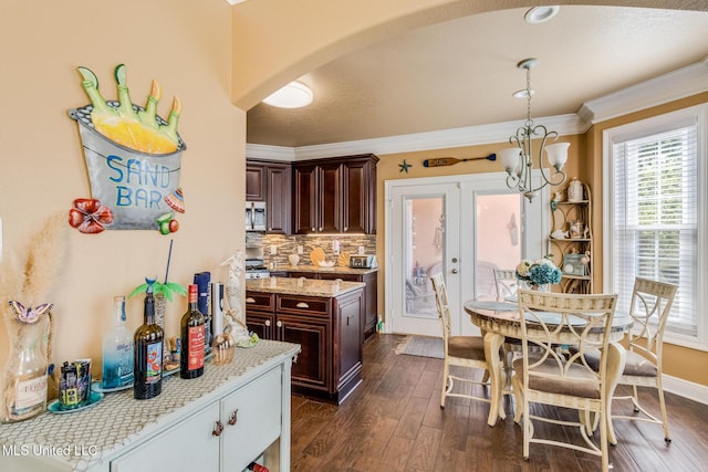 kitchen with dark brown cabinetry, french doors, dark wood-type flooring, crown molding, and decorative backsplash