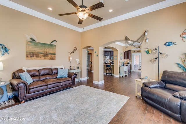 living room with ceiling fan, dark hardwood / wood-style flooring, and crown molding