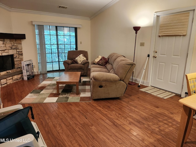 526 N 2nd St, Bay Saint Louis, MS 39520 - living area with wood finished floors, crown molding, and a stone fireplace