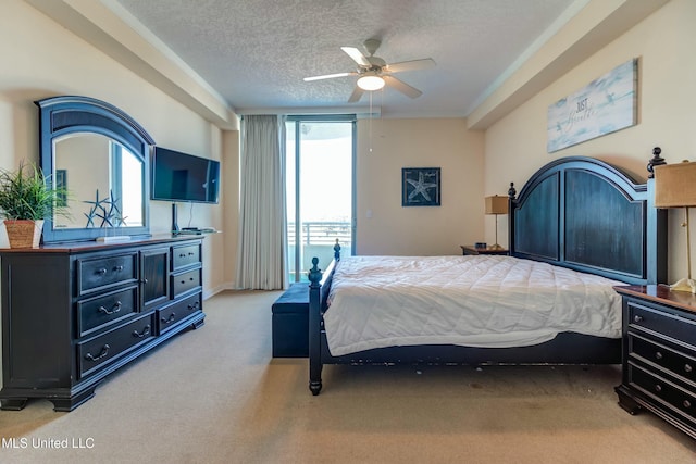 carpeted bedroom with access to exterior, ceiling fan, and a textured ceiling