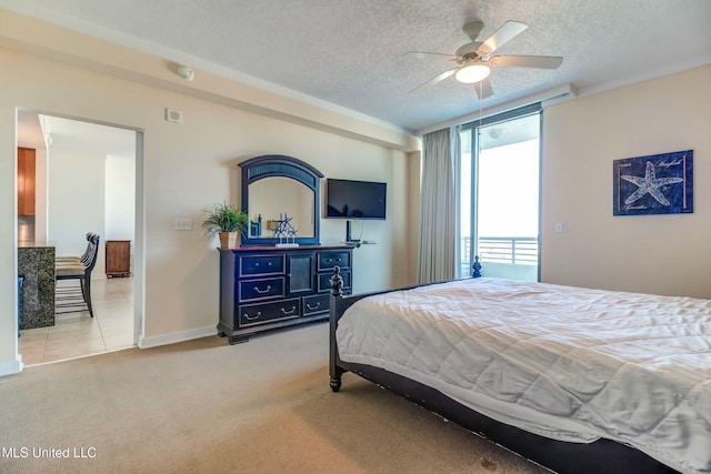 carpeted bedroom featuring expansive windows, ceiling fan, a textured ceiling, and baseboards