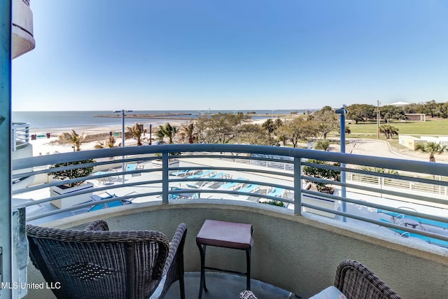 balcony with a water view and a beach view