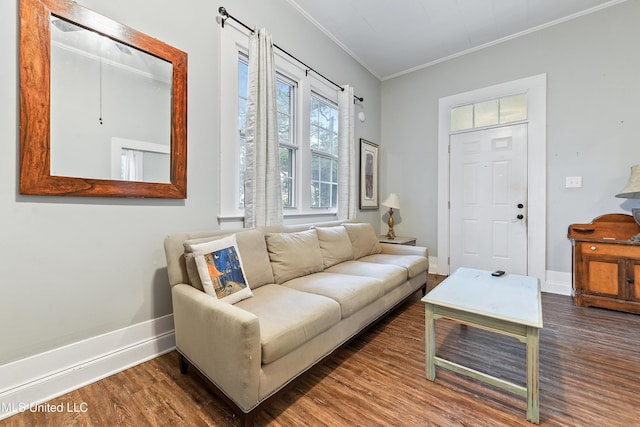 living room with dark hardwood / wood-style flooring and crown molding