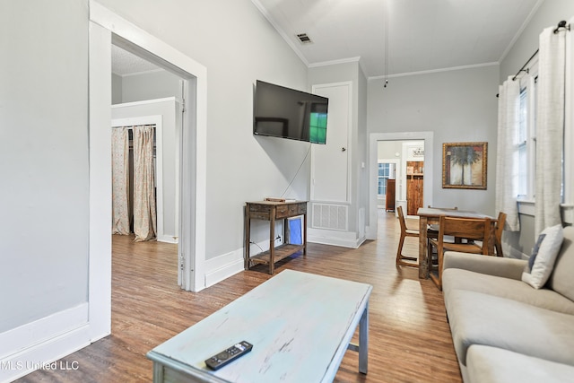 living room featuring ornamental molding and hardwood / wood-style floors