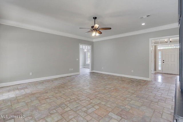 spare room with a ceiling fan, visible vents, crown molding, and baseboards