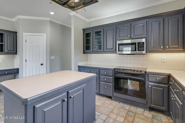 kitchen with stone tile floors, light countertops, stainless steel microwave, backsplash, and black range with electric cooktop