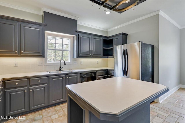 kitchen with black dishwasher, crown molding, stone tile floors, freestanding refrigerator, and a sink