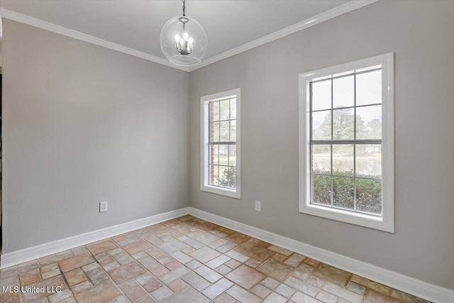 empty room featuring ornamental molding, stone finish floor, baseboards, and an inviting chandelier