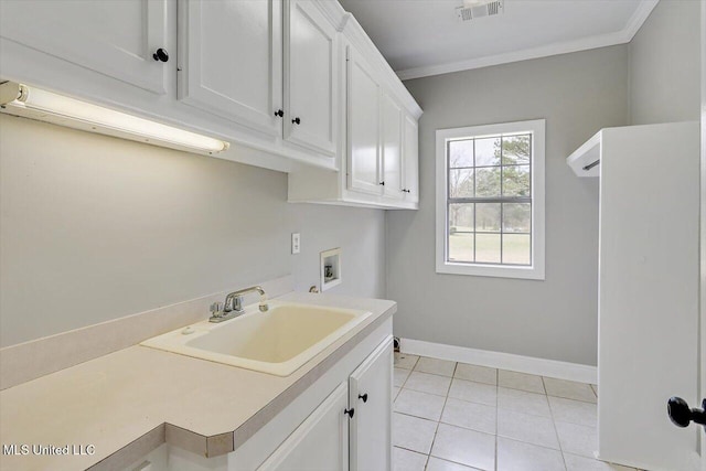 laundry room featuring hookup for a washing machine, a sink, visible vents, ornamental molding, and cabinet space