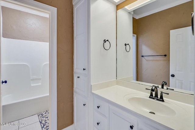 bathroom with ornamental molding, vanity, a bathtub, and tile patterned floors