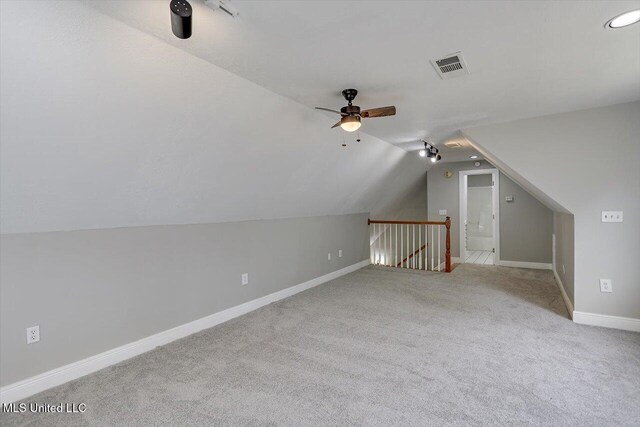 bonus room with lofted ceiling, ceiling fan, carpet flooring, visible vents, and baseboards