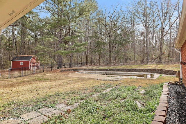 view of yard with an outbuilding and fence