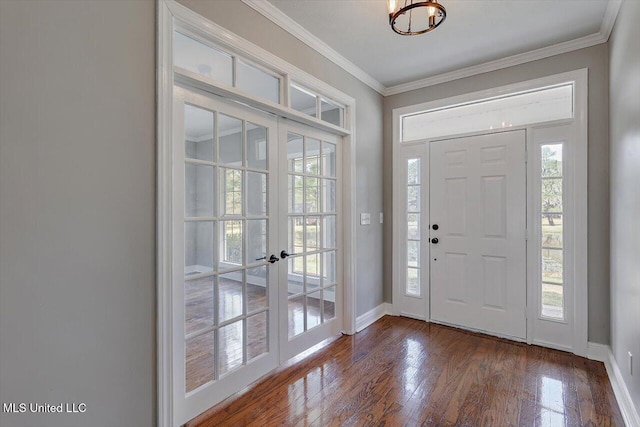 entryway featuring baseboards, dark wood-type flooring, crown molding, and french doors