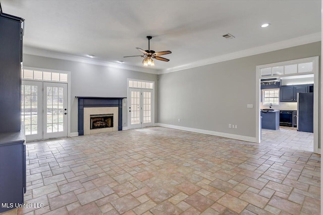 unfurnished living room with ornamental molding, visible vents, baseboards, and a premium fireplace