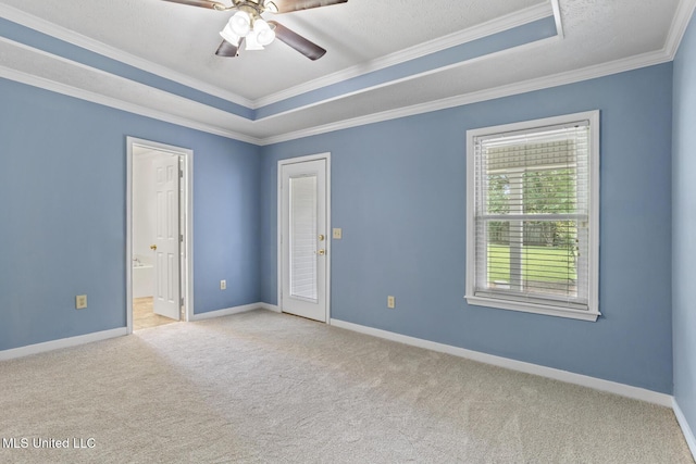 1035 N Azalea Dr, Madison, MS 39110 - spare room featuring a tray ceiling, carpet flooring, crown molding, a ceiling fan, and baseboards
