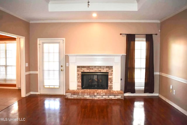 unfurnished living room featuring ornamental molding, a wealth of natural light, and dark hardwood / wood-style floors