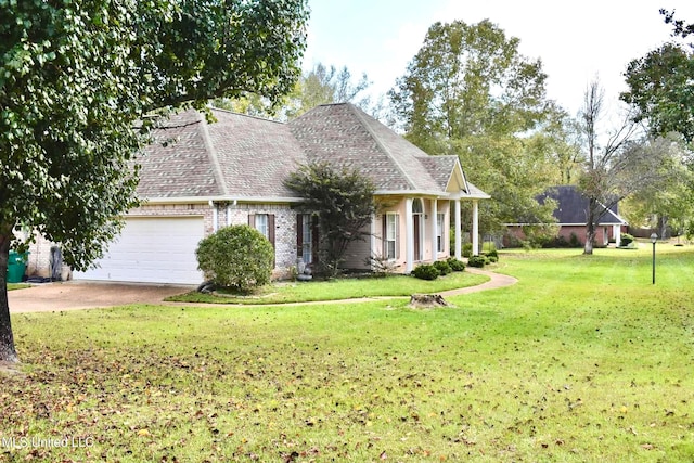 view of front of property featuring a garage and a front lawn