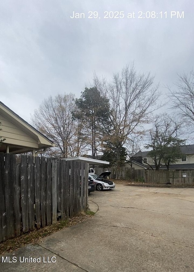 view of vehicle parking with a carport