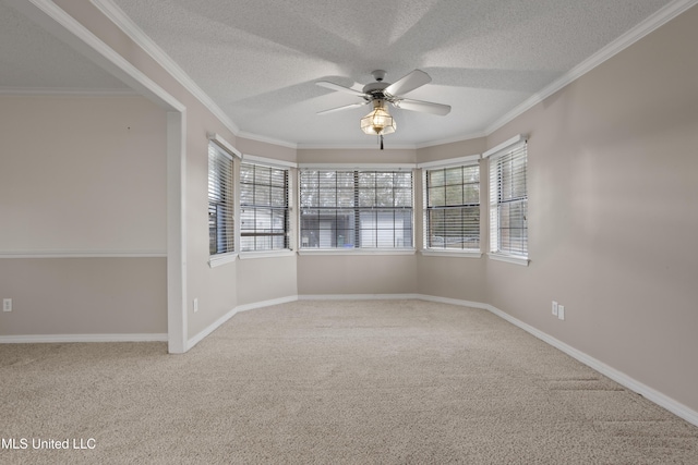 empty room with ornamental molding, a healthy amount of sunlight, and ceiling fan